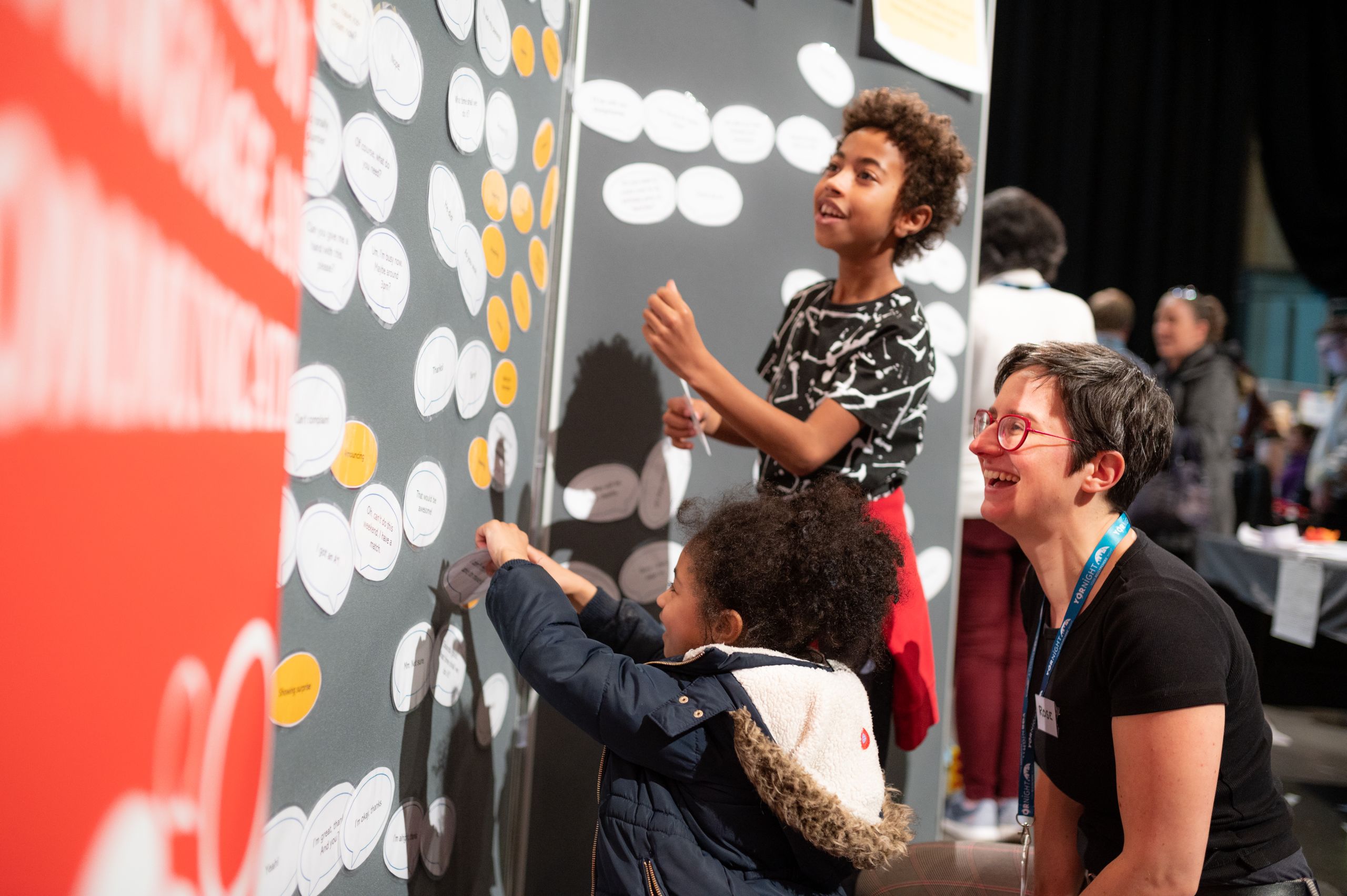 A University of York academic helps children use an interactive display as part of the research event YorNight