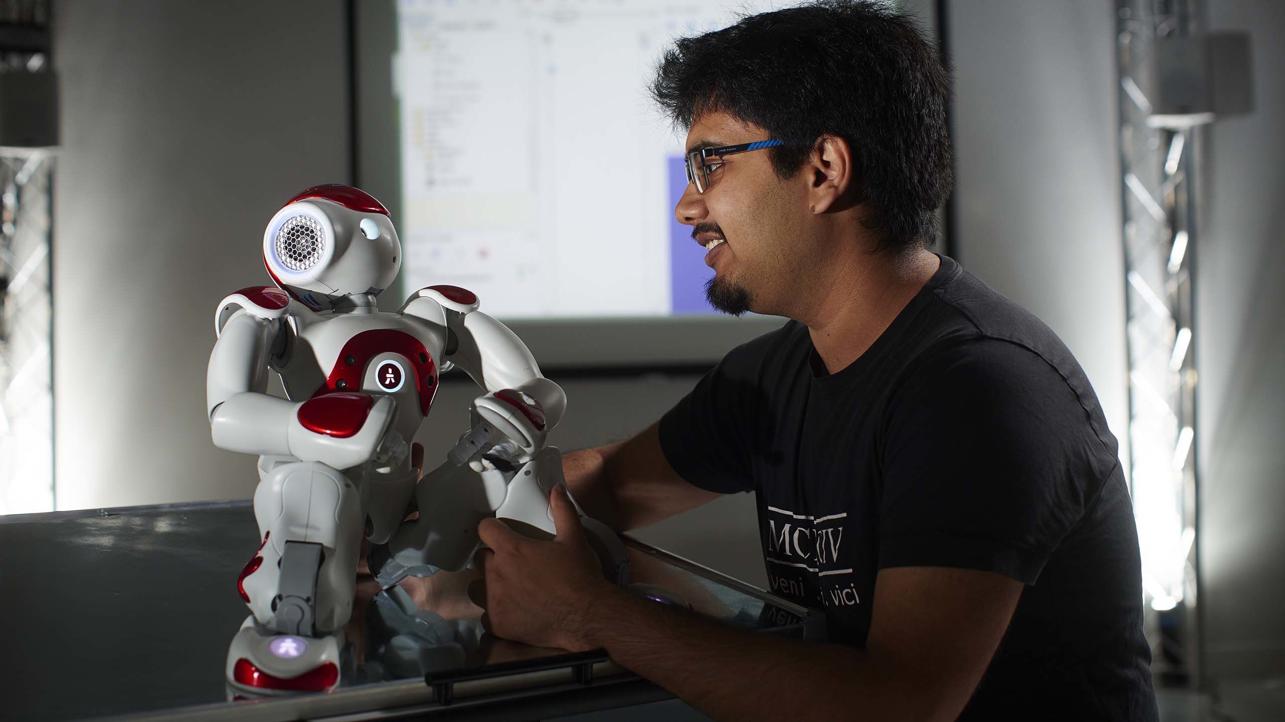 A robot and a human communicate during research in Computer Science.