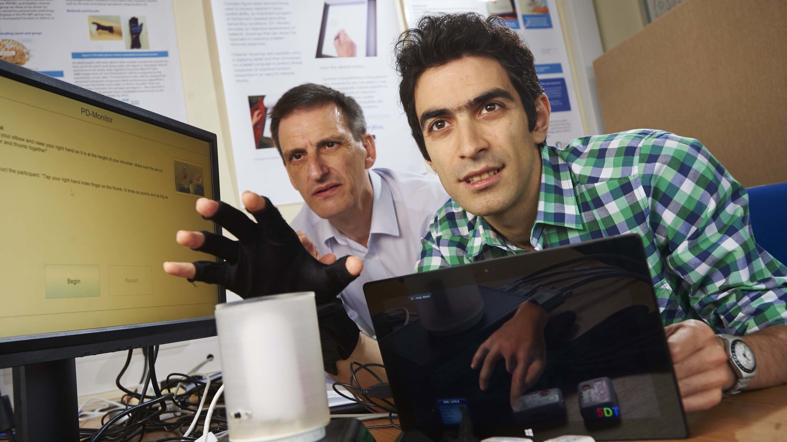 A member of academic staff and PhD student collaborating on research in Department of Electronic Engineering.