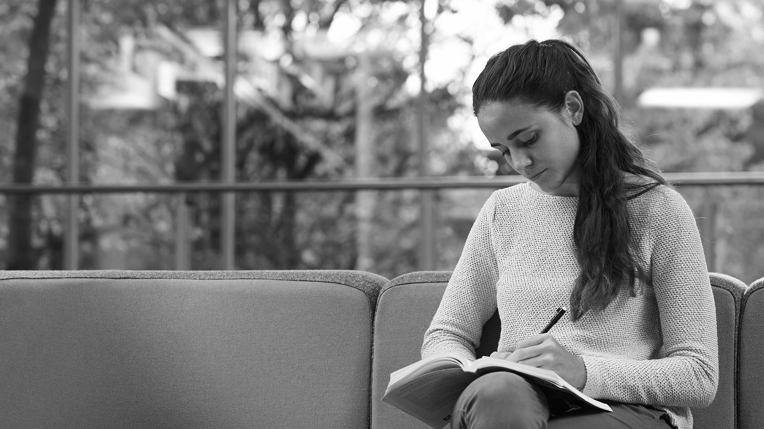 A female student writing in a notebook