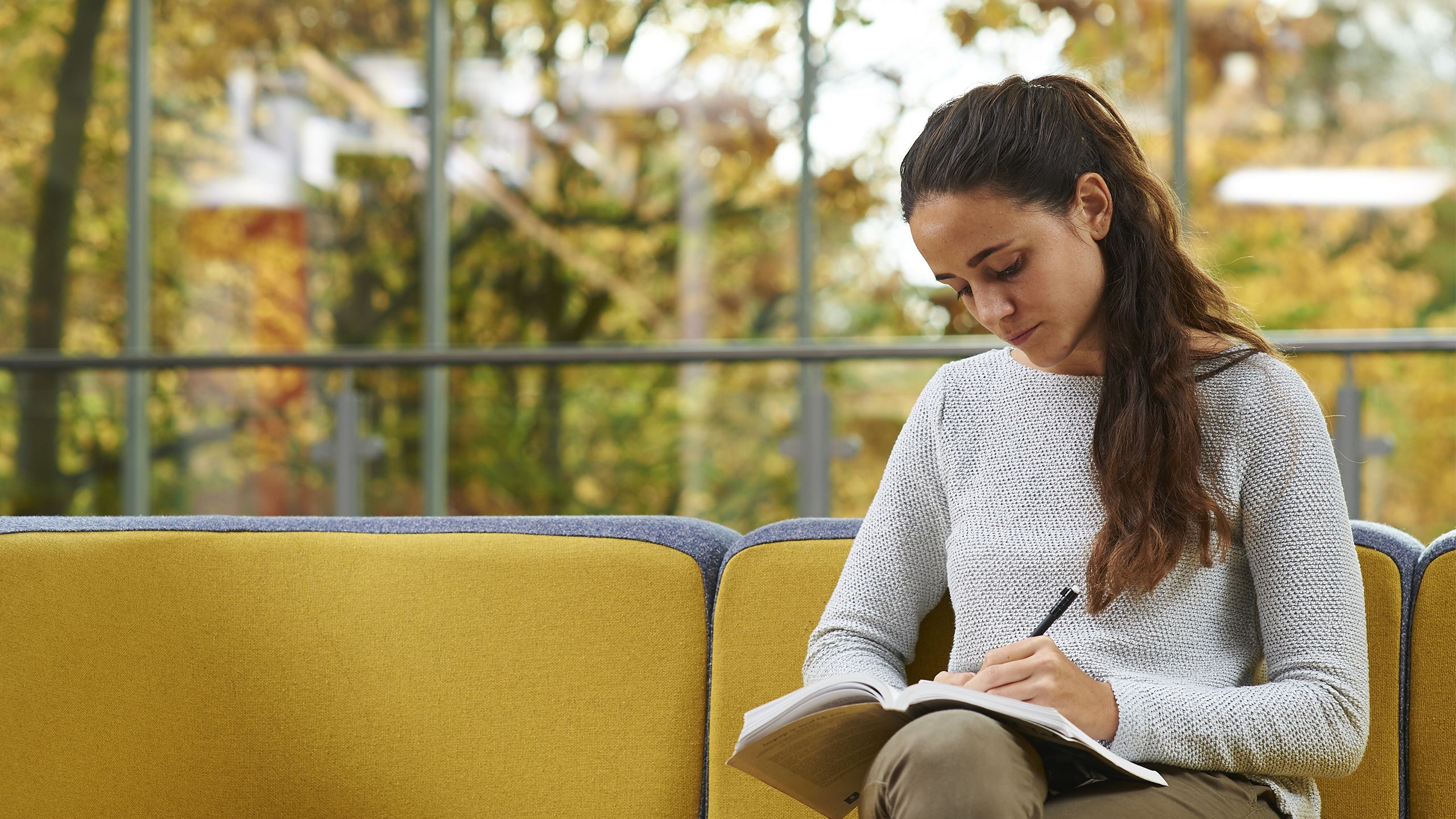 A female student writing in a notebook