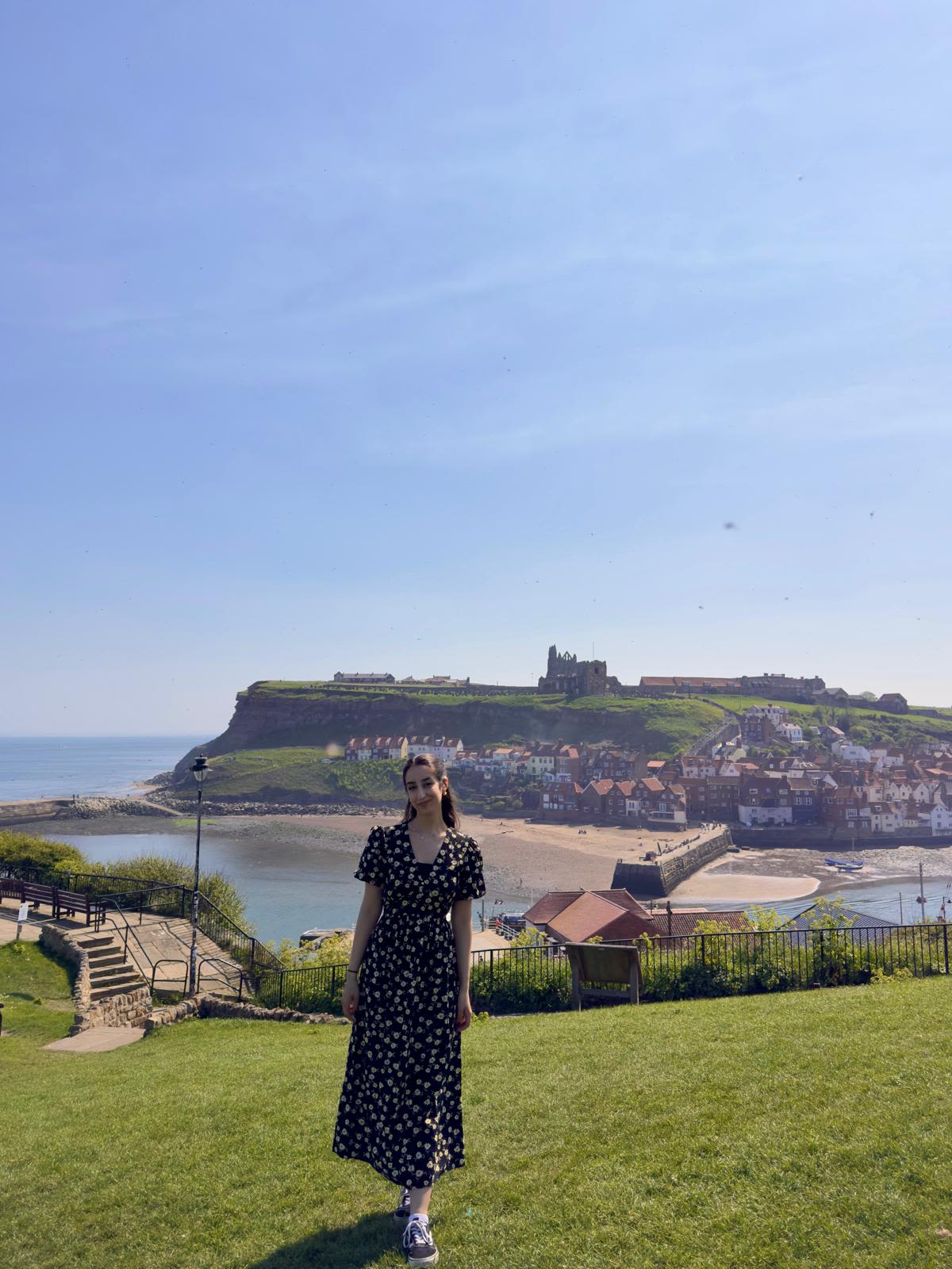 Malak, Sam Pegram scholar stood overlooking a cliff face