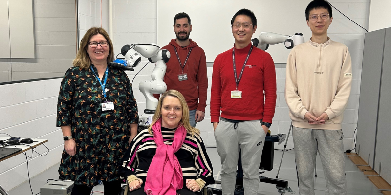 Dr. Jihong Zhu, with Ms Jane Hudson and researchers in the Institute for Safe Autonomy lab