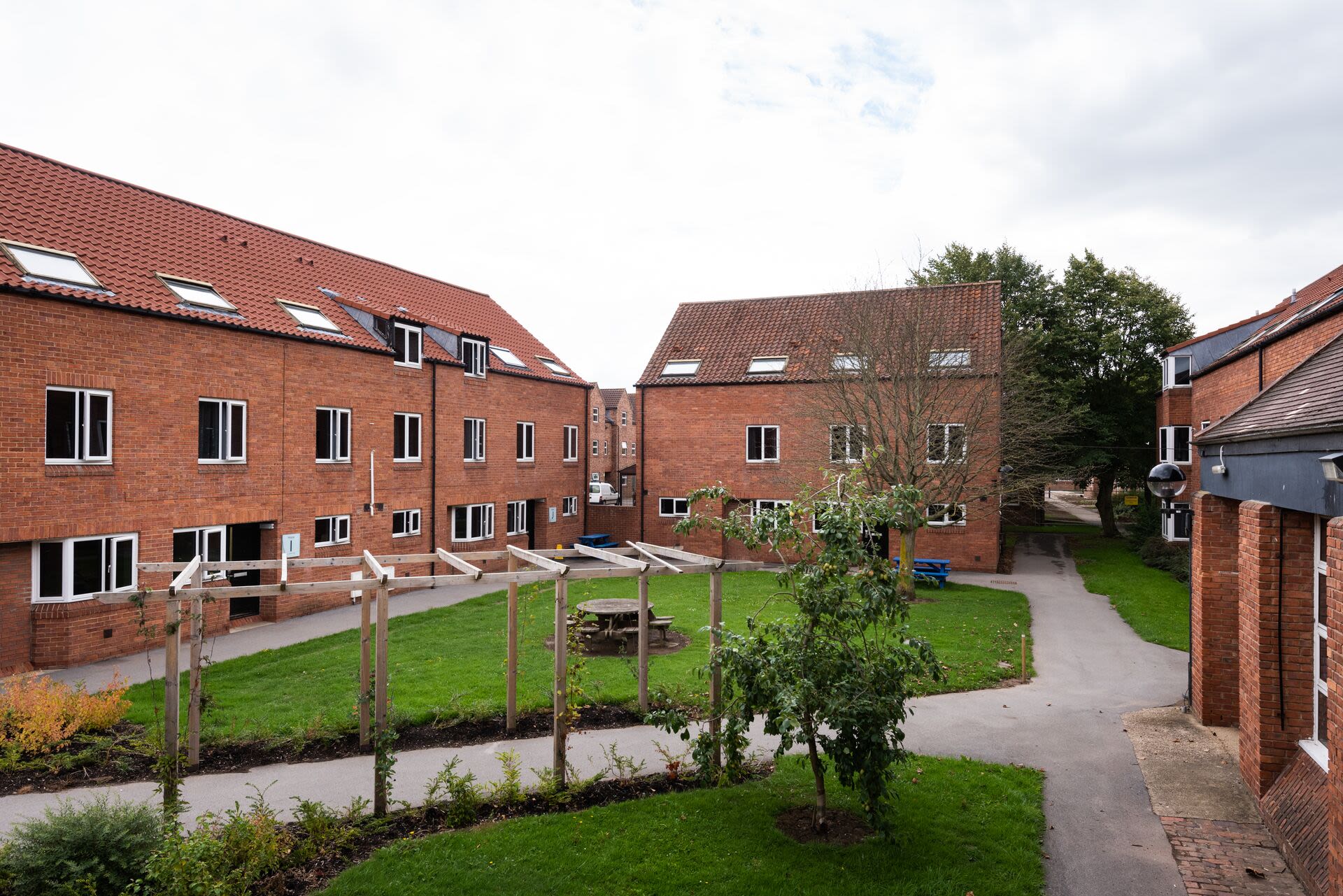 A small courtyard surrounded by red-brick houses.