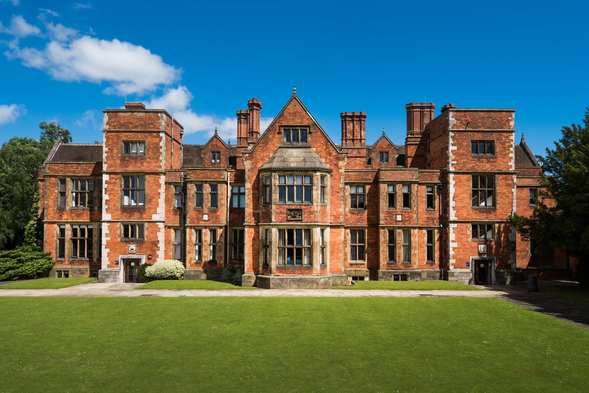 Heslington Hall on a sunny day, under a clear blue sky.