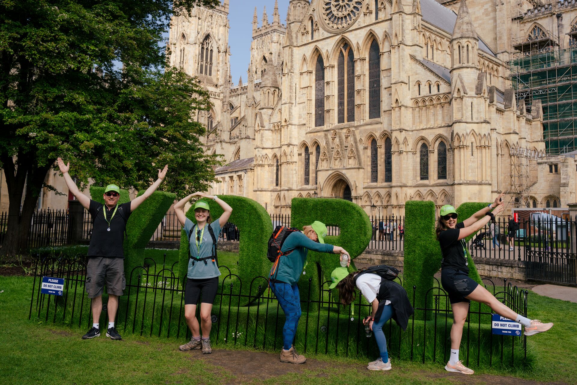 Outside York Minster, a group of five people are spelling out the word 'York' with their bodies
